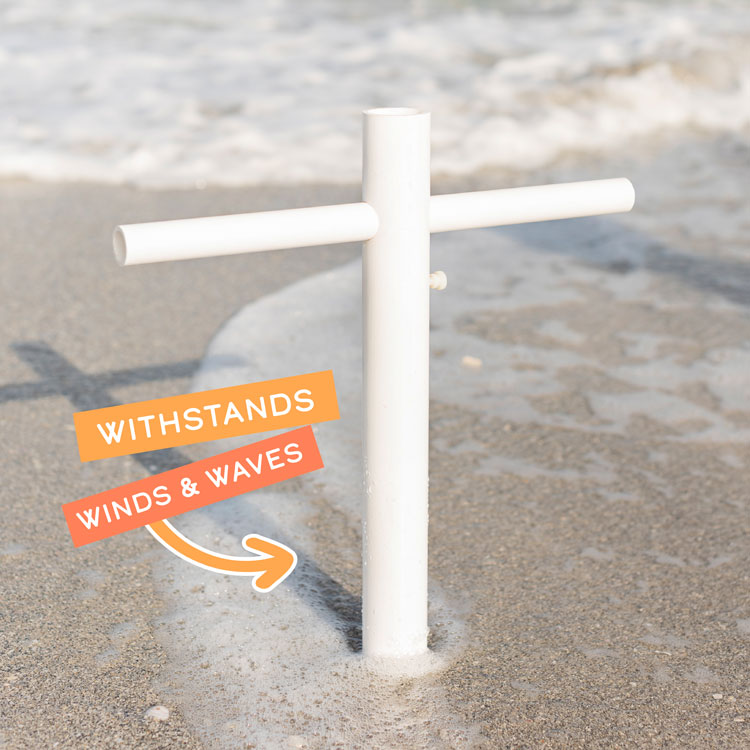 A close up of the Suncoast Beach Shade umbrella anchor in shallow water with the words "Withstands Winds & Waves" on top of the image